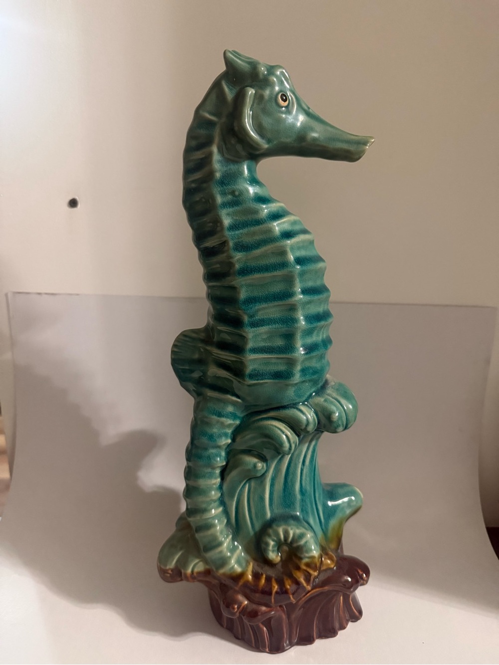 Ceramic Seahorse Figurine glossy turquoise seahorse accent brown-toned base.